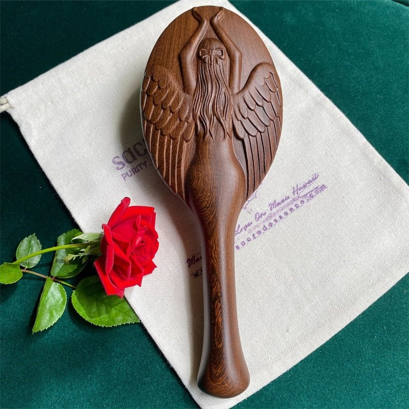 The Sacred Essence Angel Scalp Massage Brush - Product shown on white cloth