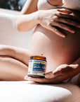 Motherlove Pregnant Belly Salve - Model shown holding product in front of belly