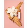 Rahua by Amazon Beauty Palo Santo Oil Perfume showing sitting on palo santo with flower