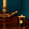 Trudon Gabriel Petite Candle lifestyle shot with candle burning on wood table